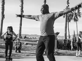 Man dancing with his arms spread out